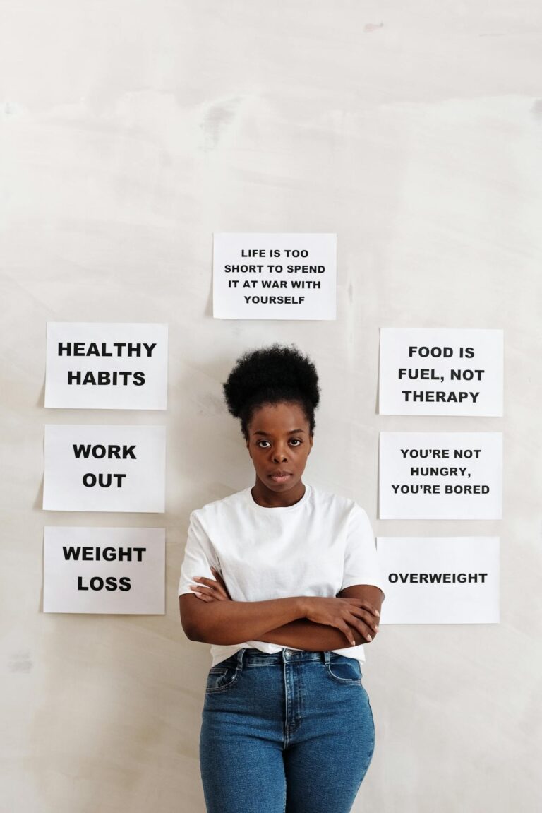 A woman stands in front of health messages promoting positive lifestyle changes.